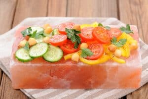 CW Services Inc: Vegetable salad on pink salt block on stripe napkin